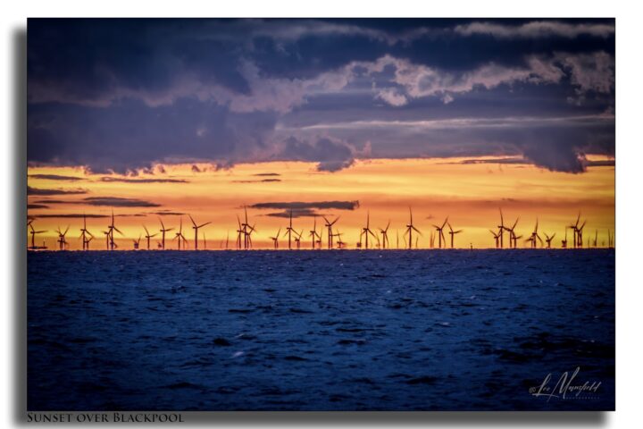 Windfarms at Sunset northern end of Blackpool seafront.