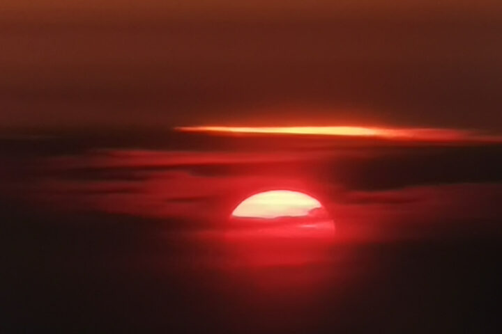 Sunset through the clouds from Plane