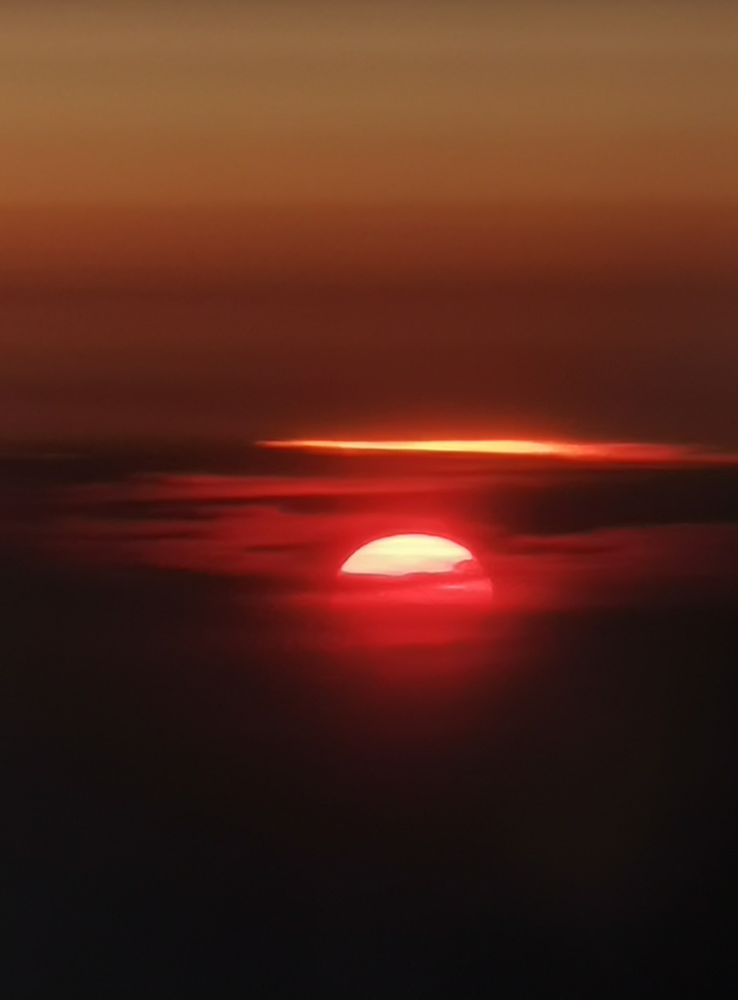 Sunset through the clouds from Plane